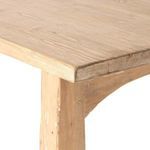 Close look at arched support base and tapering leg with aged finish details