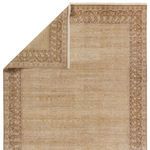 Repeat of rug top corner folded to reveal back side with hand-crafted texture