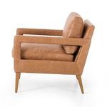 Side view highlighting the clean profile and arm cutouts of the butterscotch leather chair