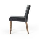 Three-quarter side view highlighting leather seating and toasted nettlewood wood leg grain
