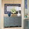 Sara Cabinet placed in an entryway with decorative mirror and layered tabletop accessories