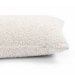Side close-up focusing on pillow zipper placement in off-white textured fabric