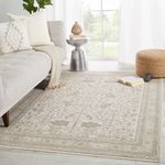Valentin Oriental Rug styled in bright living room beside beige sofa, pouf, and metal side table.
