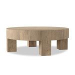 Round coffee table angled to show leg placement with shadows underneath on white background