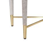 Close-up of tapered cabinet leg wrapped in gray hair-on-hide with polished brass foot and cross supports