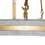 Close-up showing gold metal hook connector on wood base of chandelier