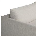 Back corner of sectional with plush back cushion slanting gently over frame