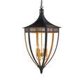 Close-up of lantern top corner with black wrought iron and gold leaf glowing from within
