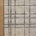 Partial top-down view highlighting the rug's fringed edges against wooden floor.