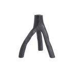 Black cast iron candle holder with three uneven, branch-like legs and a textured surface