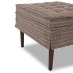 Side corner view showing fabric skirt with side handles and dark wood tapered legs