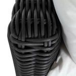 Top view of chair’s rounded woven armrest showing detailed weaving pattern
