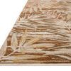 Angled view showing low pile texture and fringed edge of the earth tone botanical rug