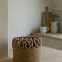 Bamboo basket placed on wooden countertop with kitchen décor in soft natural light