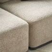Close-up of Nest Modular Sectional upholstery showing boucle texture and corner seam with dark wood base