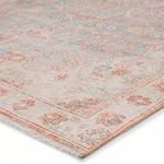 Close-up angled view showing rug’s soft chenille and cotton texture with faded orange and blue pattern details