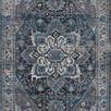 Full top-down view of Samra denim rug revealing central medallion and detailed border in muted blue and grey