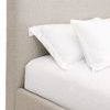 Side view focusing on upholstery near pillows and subtle texture of fabric