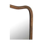 Close-up of Keyes mirror’s aged brass frame corner with subtle pinhole texture detail
