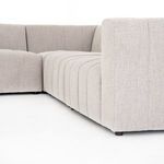 Angled lower side view of Langham sectional showing black feet and fabric texture