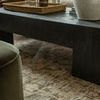 Close-up of Heritage Bark / Multi rug under a black wood coffee table with vase and books
