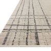 Close-up low angle showing the rug's texture and linear pattern on beige background.