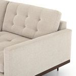 Close-up of left side armrest with sharp edges and textured pewter fabric