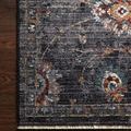 Close-up corner view of Samra rug showing intricate floral border and fringe on dark wooden floor