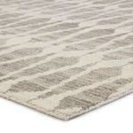 Angled close-up capturing pile height and subtle tonal shifts in light gray design