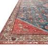 Close-up angled view showing the detailed fiber texture and pattern of the rug's corner