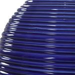Close-up showing ribbed texture and glossy finish on the indigo blue ceramic lamp base