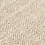 Close-up showing textured handspun jute fibers forming Chevron pattern in beige and cream