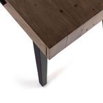 Close-up angle of the desk’s front left corner highlighting construction and finish