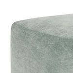 Close-up showing soft velvet texture and stitching details on pouf corner
