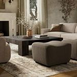 Kylo Ottoman styled with neutral sofa and dark wooden coffee table with rug underneath in living room