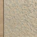 Rug corner on light wood floor highlighting detailed floral pattern and natural ivory color contrast
