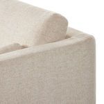 Close-up of bolstered pillow resting against loose back cushion on sectional corner