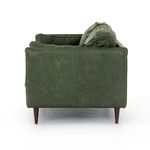 Side view capturing plush back and side cushions with leather piping