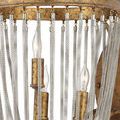 Close-up showing mesh texture of chains and flame-shaped bulbs inside gold ring