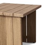 Close-up angled detail of table's top edge and side panel alignment