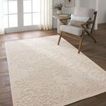 Duplicate cream rug styled in modern room with wood floor and beige armchair next to round side table