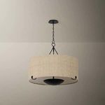 Elias chandelier hanging in room with soft light casting on smooth taupe walls, highlighting woven shade texture