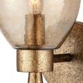 Close-up focus on textured gold metal cylinder holding the bulb under the hammered glass shade