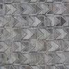 Detailed view of Beckett rug’s geometric chevron motif in overlapping gray shades