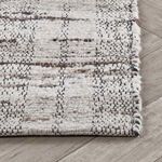 Side edge view emphasizing subtle variation in wool yarn thickness and handwoven detail