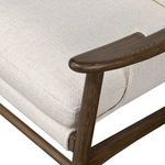 Close-up of wood armrest and boxing detail on seat cushion corner