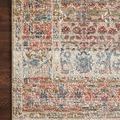 Detailed corner shot revealing rug edging and pattern contrast against dark hardwood floor