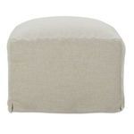 Back-side corner close-up of slipcover ottoman showing fabric weave and skirt slit detail
