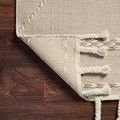 Back side and corner of Sawyer Sand Rug flipped to show weave and tassel construction