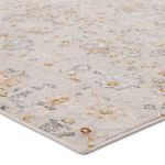 Close-up of low pile texture and pastel floral details on corner of the rug